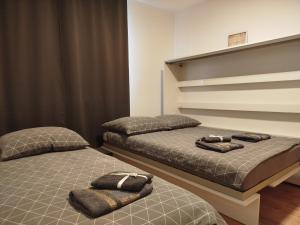 two beds sitting next to each other in a bedroom at Wakacje Puck in Puck