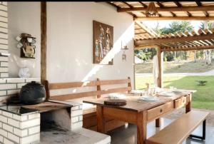 a kitchen with a wooden table and a stove at Esmeraldas GuestHouse in Esmeraldas