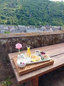 a tray of breakfast food on a wooden table at Das Alte Pastorat in Klotten