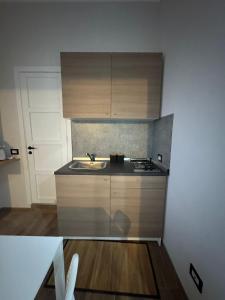 a small kitchen with a sink and a stove at Casa Camurria in Aci Castello