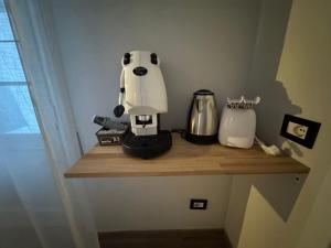 a coffee maker sitting on a wooden shelf at Casa Camurria in Aci Castello