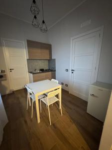 a kitchen with a table and chairs in a room at Casa Camurria in Aci Castello +19 photos