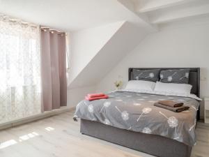 a bedroom with a bed and a large window at Kokett Apartment in Neu-Ulm