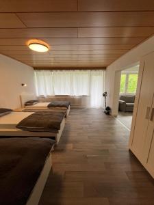 a room with three beds and a couch at Stay 15 Kassel in Kassel