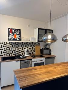 a kitchen with a stove and a counter top at Indigo Apartment in Kassel +10 photos