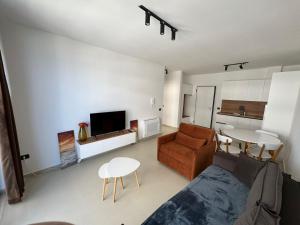 a living room with a couch and a table at Driton`s Apartments in Shëngjin