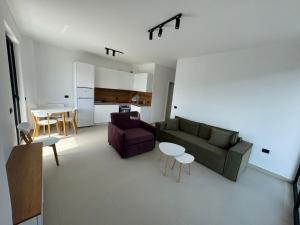 a living room with a couch and a table at Driton`s Apartments in Shëngjin +20 photos