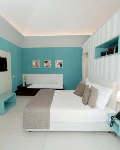 Postel nebo postele na pokoji v ubytování Villa Gervasio Rooms