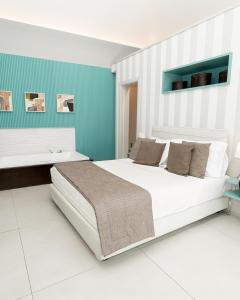 Postel nebo postele na pokoji v ubytování Villa Gervasio Rooms
