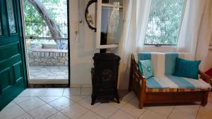 a living room with a chair and a mirror at Casa Nonna Traditional guest house in Oziás +19 photos