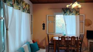 a dining room with a table and chairs and a window at Casa Nonna Traditional guest house in Oziás
