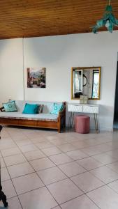 a living room with a couch and a mirror at Casa Nonna Traditional guest house in Oziás