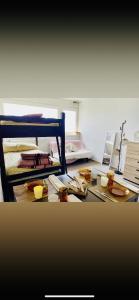a room with a bed and a table with plates and bowls at Prapoutel Sept Laux Namaste in Les Adrets