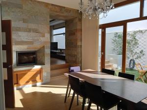 a dining room with a stone wall and a table and chairs at Luna Bermeja in Casabermeja