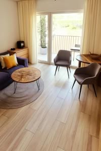 a living room with a couch and a table at Apartment, private garage, balcony, smart check in in Banská Bystrica