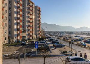 a parking lot with cars parked in a city at KOA - Sunlight Apartment in Braşov