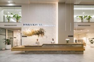 a lobby with two people sitting at a reception desk at RIKKA KHUST thermal resort in Khust +96 photos