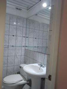 a white bathroom with a toilet and a sink at Miraflores, Lima, apartamento 2 dormitorios in Lima +16 photos