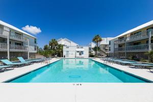 a swimming pool in front of a building at Cotton Bayou Unit 4F in Orange Beach