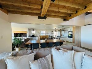 a living room with a couch and a table at Bayview Bliss at Springerbaai Luxury Eco Villa with Ocean Views & Beach Access in Mossel Bay