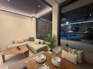 a living room with a couch and a table at Aqua Vista Retreat in Cabo Negro