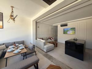 a living room with a couch and a table at Aqua Vista Retreat in Cabo Negro