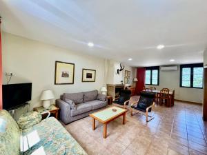 a living room with a couch and a table at Apartamentos Rurales el Chaparral in Arroyo Frio