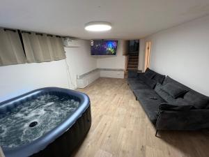 a living room with a couch and a large tub at Sea side Ashdod יא in Ashdod