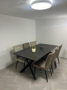 a black table with chairs and a potted plant on it at Sea side Ashdod יא in Ashdod
