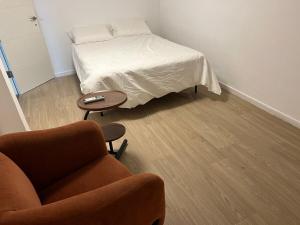 a bedroom with a bed and a couch and a table at Sea side Ashdod יא in Ashdod