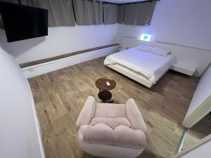a room with a couch and a bed and a television at Sea side Ashdod יא in Ashdod