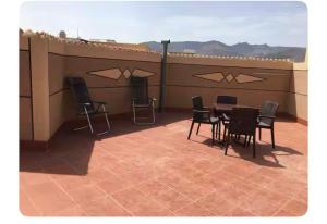 a patio with chairs and a table on a roof at Marhaba in Nador