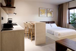 a hotel room with a bed and a kitchen at Reve Suites Ioannina in Ioannina +54 photos