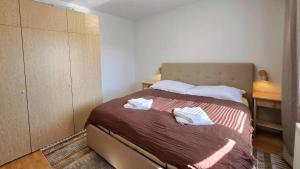 a bedroom with a bed with two towels on it at Urban Zen Stay in Banská Bystrica