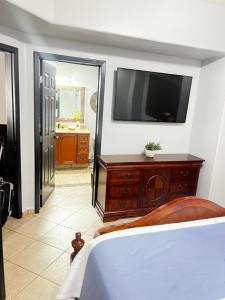 a bedroom with a bed and a television on a wall at Las Palomas Beach & Golf Resort in Puerto Peñasco +56 photos