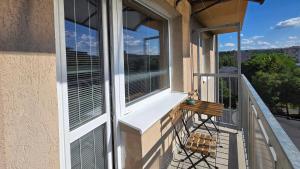 a balcony with a chair and a window at Urban Zen Stay in Banská Bystrica +2 photos