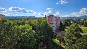 an overhead view of a city with trees and buildings at Urban Zen Stay in Banská Bystrica