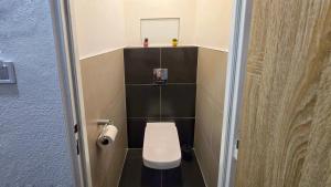a small bathroom with a toilet and a mirror at Urban Zen Stay in Banská Bystrica