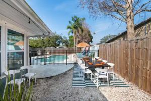 a patio with a table and chairs and a pool at Ruby & Cash Vacations 1 in Seminole