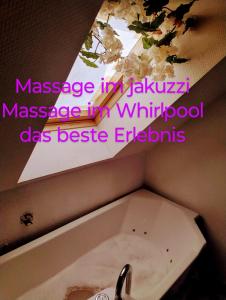 a sink in a bathroom with a mirror and a sink at Massage studio-spa in Ginsheim-Gustavsburg