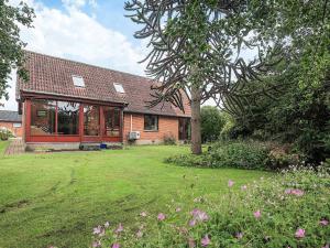 a house with a large yard with a tree at 10 person holiday home in Spøttrup in Spottrup