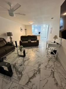 a living room with two couches and a table at Duplex on CANAL all updated new furniture in Rotonda West
