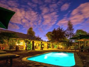 a swimming pool in the yard of a house at Urban Camp in Windhoek