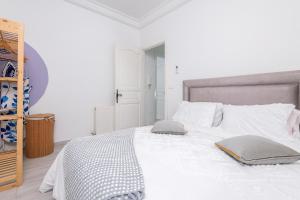 a white bedroom with a large bed with two pillows at Chic escape at Sidi Bousaid in Dar Salah Bey +11 photos