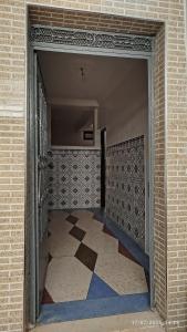 an open door to a hallway with a tile floor at Peaceful family apartment in Agadir