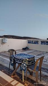 a table and two chairs sitting on a roof at Peaceful family apartment in Agadir