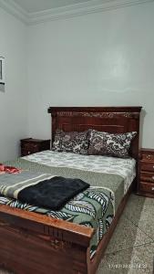 a bedroom with a bed with a wooden frame at Peaceful family apartment in Agadir