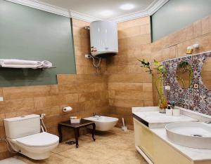 a bathroom with a toilet and a sink at GA Plus Hotel in the heart of Cairo in Cairo