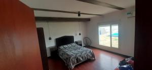 a bedroom with a bed and a window at La paz in Médanos