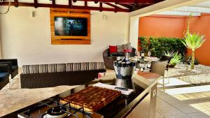 a kitchen with a stove and a table with chairs at Casa do Lago em Londrina in Londrina +57 photos